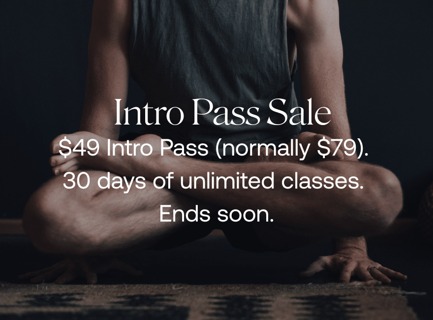 a man holds himself up on his hands in a yoga pose
