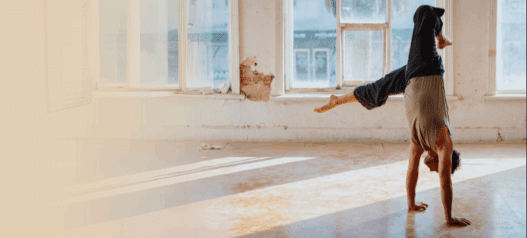 a man does a handstand in an open loft